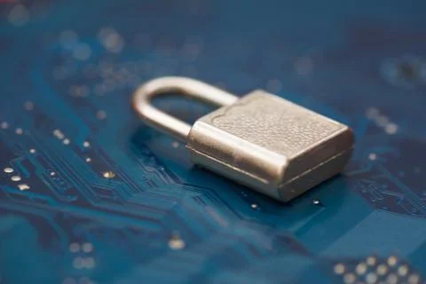 Closed security lock on background blue computer printed circuit board. Cyber Stock Photos