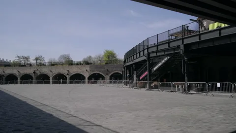 Closed shops behind fencing in an empty pedestrian precinct Stock Footage 130276795