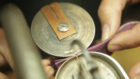 Closed shot of an old leather sewing machine, pass a needle and thread. Stock Footage 274415565