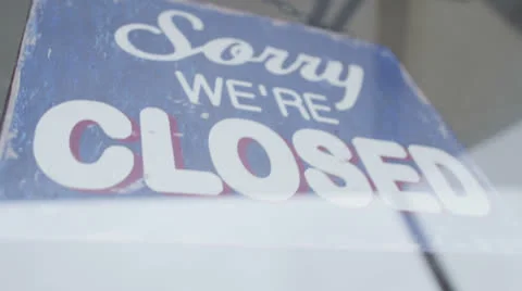 'Closed' sign is turned to 'Open' in a storefront window Stock Footage 23312008