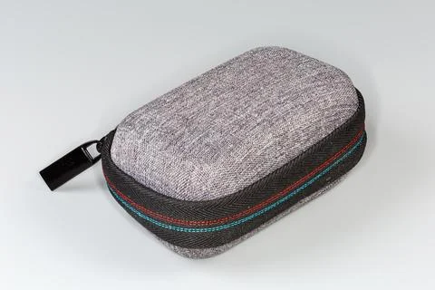 Closed small plastic hard case with zipper on gray background Stock Photos