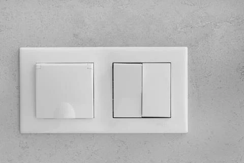 Closed socket and switch on the wall in the bathroom Stock Photos