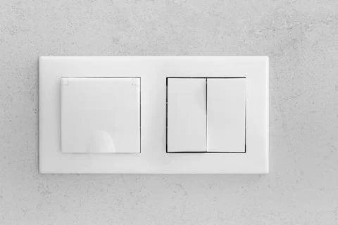 Closed socket and switch on the wall in the bathroom Stock Photos
