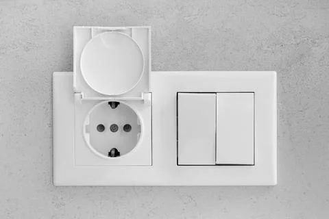 Closed socket and switch on the wall in the bathroom Stock Photos