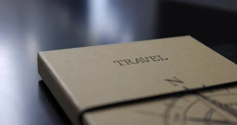 Closed travel book wrapped with string lying on a black table stop travelling Stock Footage 150154840