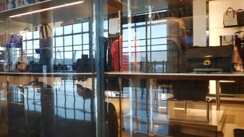 Closed TUMI store at IAH with reflected traveler Stock Footage 129260483