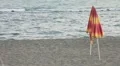 A closed umbrella on the beach HD Footage