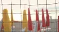 Closed umbrellas and chairs on the beach at sunset HD Footage