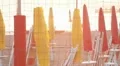 Closed umbrellas and chairs on the beach at sunset HD Footage