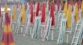Closed umbrellas and chairs on the beach at sunset HD Footage