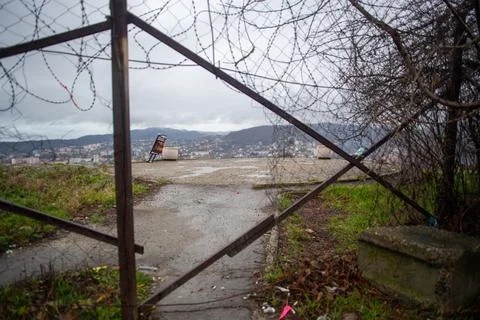 Closed viewpoint overlooking refinery behind metal fence structure Stock Photos