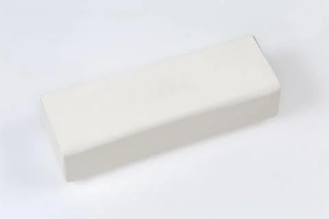 Closed white hard spectacle-case on a white surface Foto stock