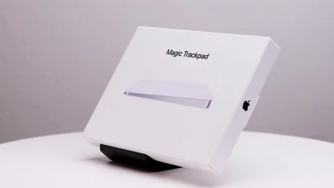 Closed white package box of new Mac magic trackpad on display stand with Stock Footage 174712882