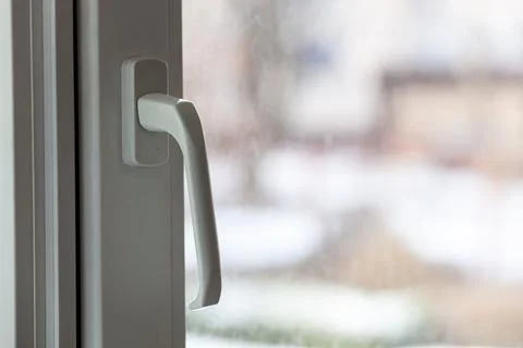 Closed white plastic pvc window in winter on a cloudy day. Stock Photos