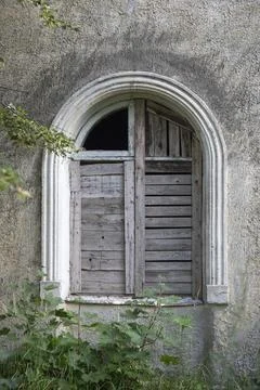 Closed window of an abandoned house. Stock Photos
