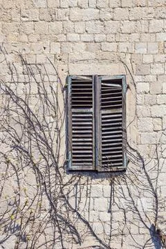 Closed window in ancient stone wall. Montenegro. Free space for text Stock-Fotos