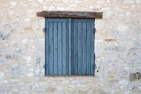 Closed window shutters in a stone wall Stock Photos