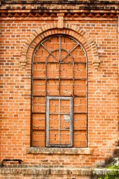 Closed windows in old orange brick wall Stock Photos