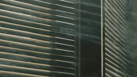 Closed wooden shutter with light rays and smoke Stock Footage 237606600