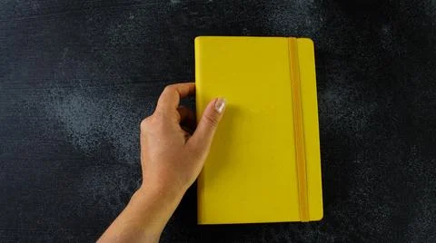 Closed yellow notepad Stock Photos