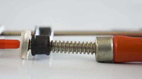 Closer look of the clamp tool with the red capsule medicine Stock Footage 129458254