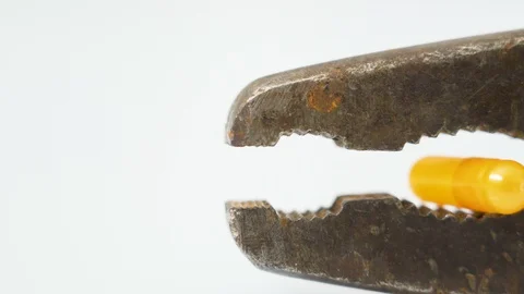 A closer look of the rusty old pliers with the yellow capsule Stock Footage 129456013