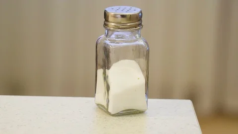 Closer look of the salt jar on the edge of the table Stock Footage 102746256