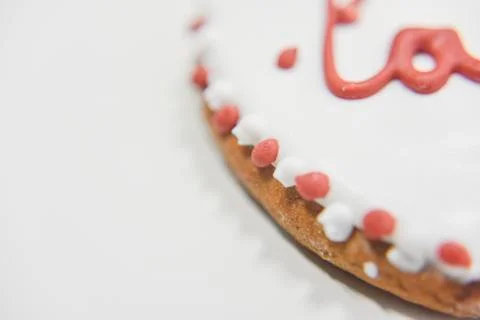 Closer look at the side of ginger cookie with sugar layer and word Love Stock Photos