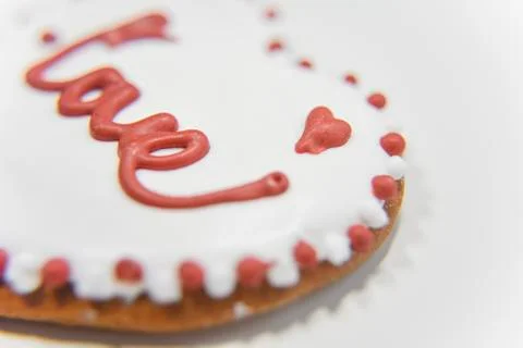 Closer look at the side of ginger cookie with sugar layer and word Love Stock Photos