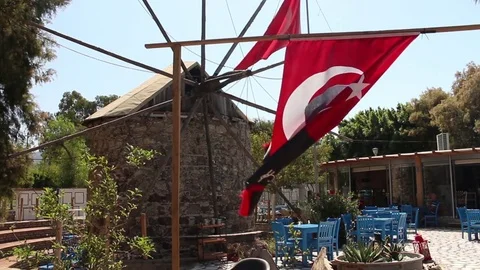 Closer shot of old windmill in cafe gardens in Yalikavak, Turkey Stock Footage 83076425
