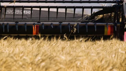 Closer slow motion shot of harvester working a wheat field. Stock Footage 86898700
