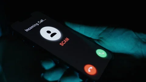 A closer view of the phone displaying a "SCAM" alert, emphasizing the choice to Stock Footage 285167038