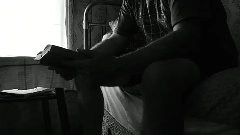 Closes the book and puts it on the table by the window Stock Footage 133024629