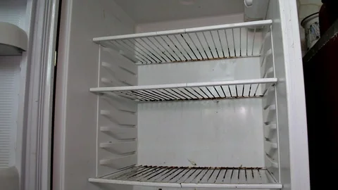 Closes the door of an empty old refrigerator Stock Footage 102396297