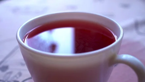 Closeu-up. Reflection in the cup of red tea Video stock 73828523