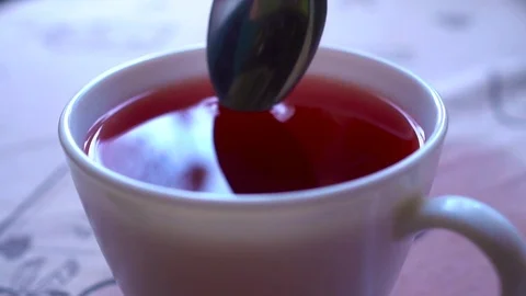 Closeu-up. Stir tea with a spoon in slowmo Video stock 73828581