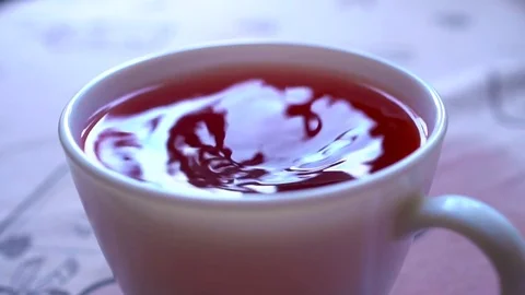Closeu-up. Stir tea with a spoon in slowmo Stock-Footage 73828603