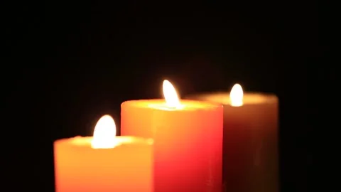 Closeuo three candlelight in a dark, concept religion background Stock Footage 143910349