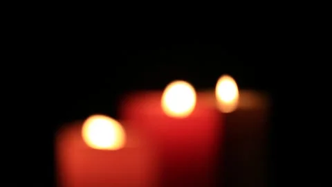 Closeuo three defocused candlelight in a dark Stock Footage 143650299