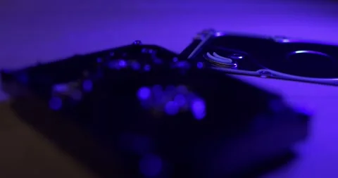 Closeup of 3.5" Hard Drive, pulling focus over Hard Disk under blue light Stock Footage 132078336