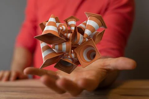 Closeup of a 3D rendered bunch of under construction signs in a man's hand 스톡 사진