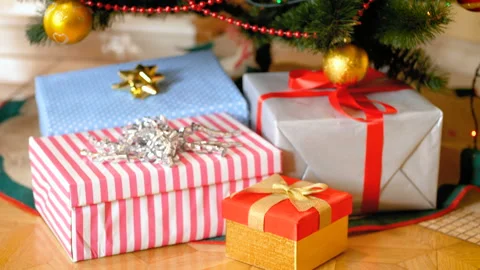 Closeup 4k footage of stack of gift boxes under Christmas tree at living room Stock Footage 94540432