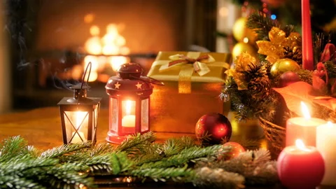 Closeup 4k panning video of burning candles, lanterns, gifts, preents, Christmas Stock Footage