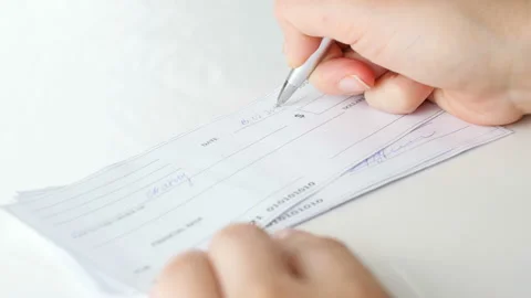 Closeup 4k video of young woman signing 1000 dollars bank cheque with pen Stock Footage