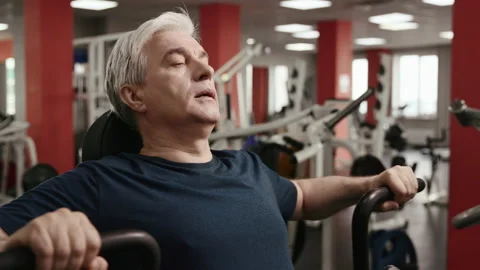 Closeup of 60s Senior Working out Inside Fitness Hall. Stock Footage 199478906