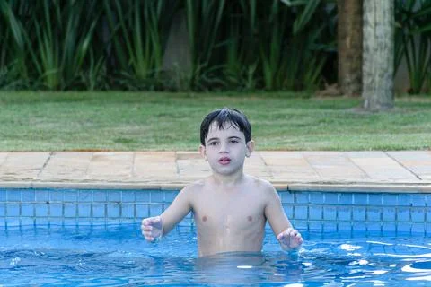 Closeup of 8 year old kid in the pool, waiting for the ball to be thrown for  Stock Photos
