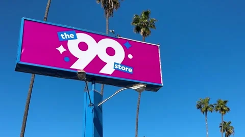 Closeup of the 99 Cent Only Store Sign Spinning in Front of a Blue Sky Stock Footage 271702998