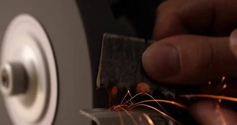 Closeup of abrasive disc on bench grinder machine Video stock 233592539