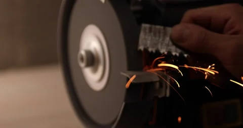 Closeup of abrasive disc on bench grinder machine Video stock 233596220