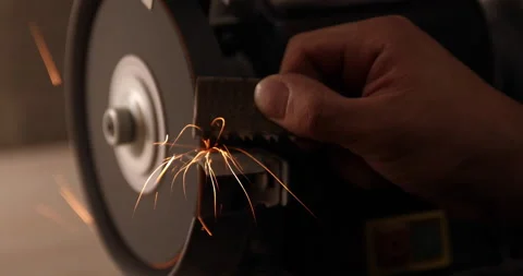 Closeup of abrasive disc on bench grinder machine Video stock 233597217